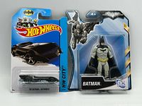 Front view of both sealed items: Hot Wheels Batmobile and Batman figure