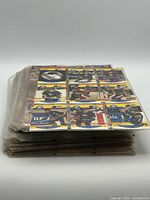 Stack of plastic sheets filled with hockey cards, showing front faces