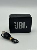 Front view of JBL GO2 speaker with USB cable