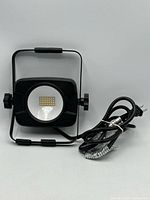 Front view showing LED array, lens, stand and cord