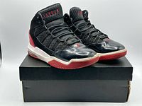 Side three-quarter view of both shoes on box showing overall design and midsole wear