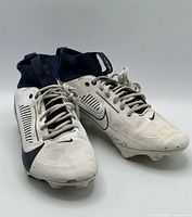 Front three-quarter view of both cleats showing uppers, laces, colorway, visible wear