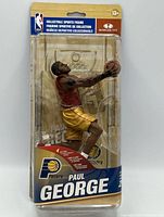 Front view of sealed Paul George action figure in packaging