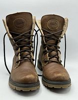 Front view showing lace-up design, Roots logo patches, and sherpa lining