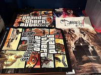 Overview of four folded video game posters on tabletop