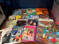 Full group shot showing all 18 records spread on table