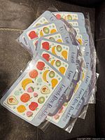 Multiple sealed sticker packs fanned out showing front design