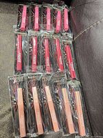 All 15 Jordache lip glosses in three rows of five, sealed in original packaging