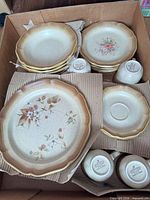 Plates, bowls and mugs stacked in box