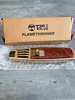 Torch lighter on bubble wrap in front of branded box