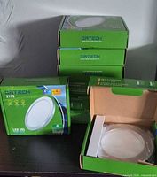 Stack of eight ORTECH 2135 LED downlight boxes, one open displaying fixture