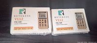 Two boxed Retekess V112 FM/AM radios on tabletop