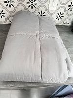 Folded gray blanket on countertop