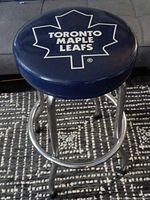 Full stool showing seat logo and frame