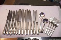 All 18 pieces laid out showing knives, ladles, forks