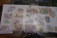 Overview of nineteen glassine envelopes filled with assorted stamps