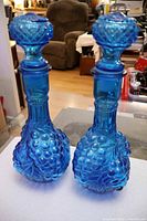Two blue glass decanters full view