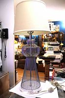 Full view of chrome cage table lamp with shade