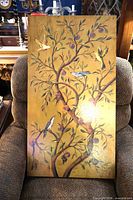 Full view of rectangular canvas print leaning on chair