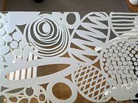 Close-up of glass top showing white abstract pattern