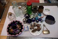 Group shot showing all 32 pieces including bottles, marbles, sombrero hat, figurines, decanter tags, inkwell and other small items