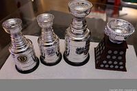 Four miniature trophies lined in a row on towel