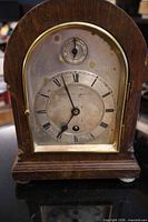 Front view of mantel clock showing entire case and dial