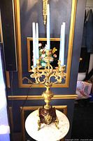 Full view of candelabra with five candles inserted, showing overall form and scale