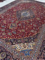 Full view of Kashan rug showing overall pattern and borders