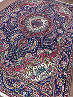 Full view of Persian Tabriz area rug showing overall design and size