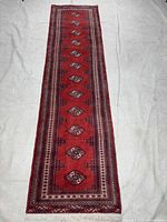 Full view of red Torkaman runner rug showing size and design