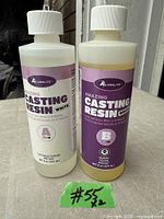 Front view of two Alumilite Amazing Casting Resin White bottles, Part A and Part B, showing labels and fill levels