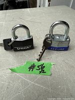 Both padlocks standing on table showing bodies, shackles and keys