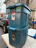 Two stacked blue Rubbermaid Roughneck totes with lids