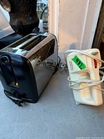 Toaster and mixer on tabletop, cords visible