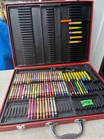 Open case showing crayons and markers in tray