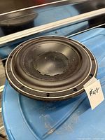 Front view of black 9.5 inch speaker driver with mounting holes