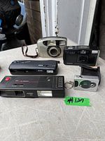 Group shot of five vintage cameras on table