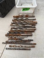 All drill bits laid out showing quantity, varying sizes and rust