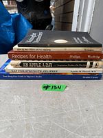 Stack of six paperback books showing all spines