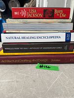 Front view of stacked books showing titles and spines