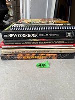 Stack of six cookbooks showing spines for identification