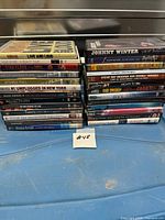 Two stacks of DVD cases displayed on blue surface