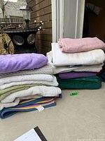 Stacks of assorted towels in various colors on table