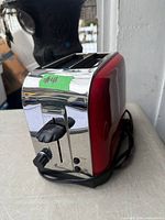 Front and side view of red Toastmaster 2-slice toaster with cord