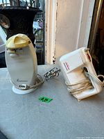 Toastmaster can opener and Sunbeam MixMaster hand mixer on table