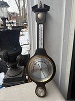 Full view of wooden barometer-thermometer showing overall design