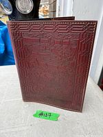 Front view of embossed leather book cover