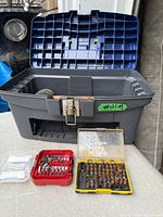 Overall view of toolbox, lid open, three bit sets in foreground