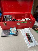 Overview showing red toolbox open with contents and additional items